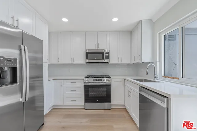 a kitchen with a sink stove and refrigerator