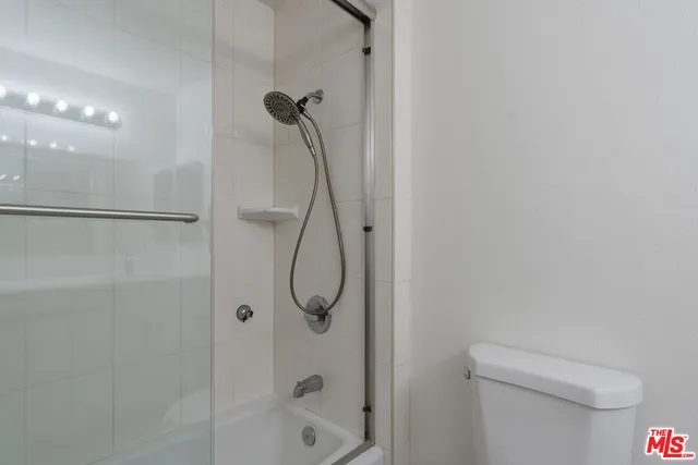 a bathroom with a shower and a toilet