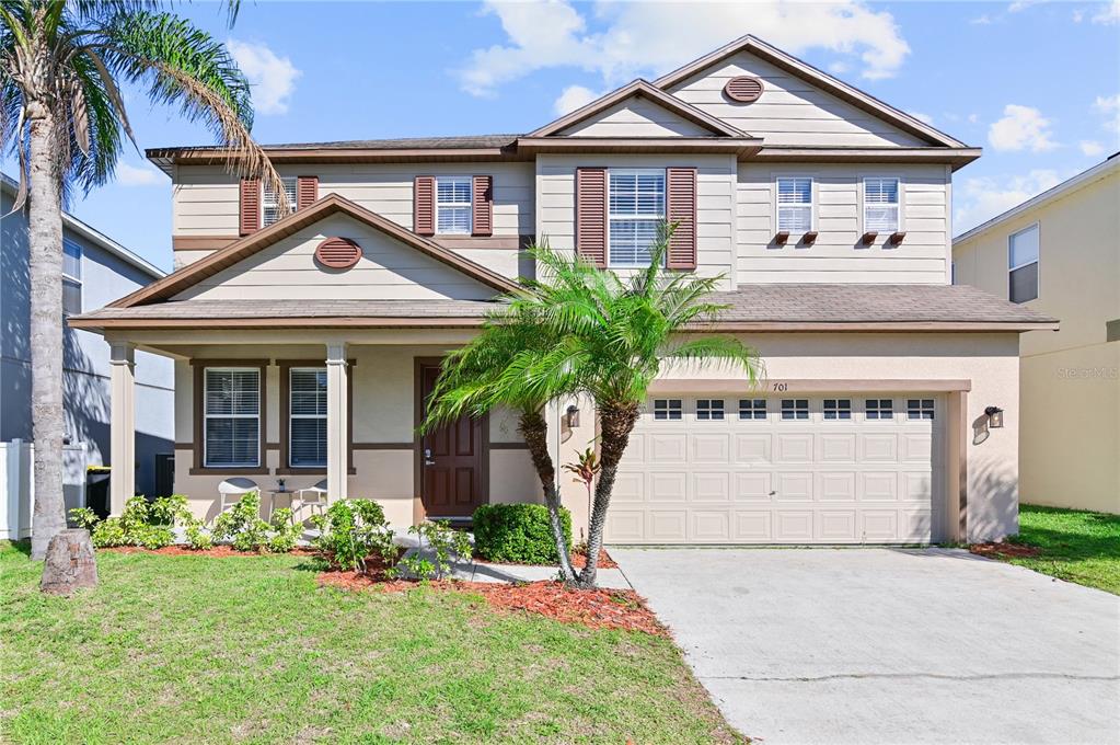 a front view of a house with a garden and plants
