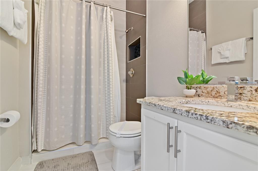 701 Kettering Road Davenport, FL 33897 - Photo 14 of 41 a bathroom with a granite countertop sink and a mirror