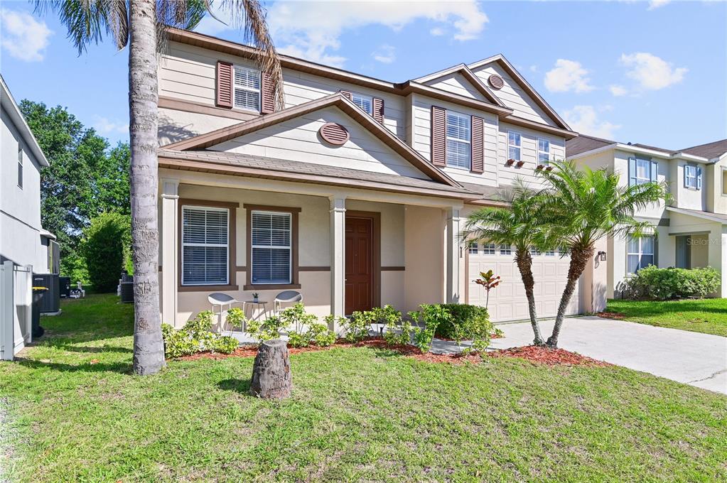 701 Kettering Road Davenport, FL 33897 - Photo 2 of 41 a front view of a house with garden