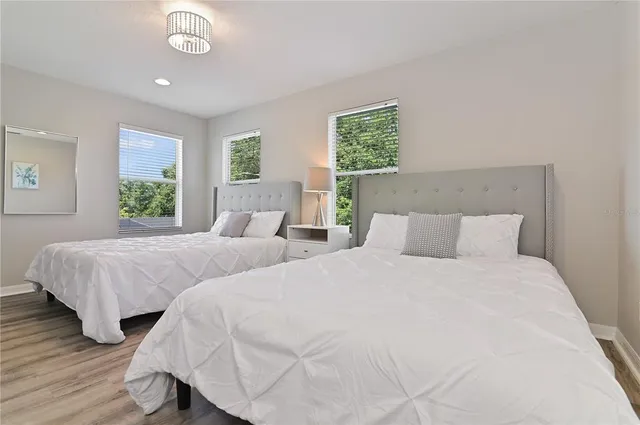 a bedroom with two beds and a window