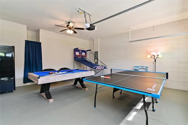 a room with pool table and windows