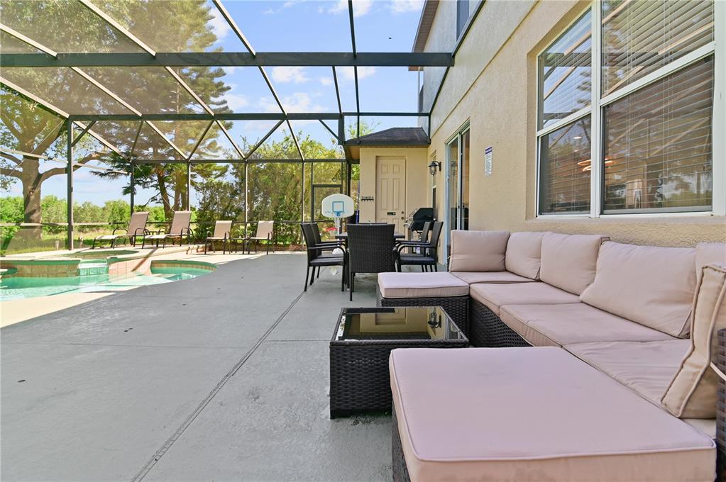 701 Kettering Road Davenport, FL 33897 - Photo 32 of 41 a view of a patio with couches and a table and chairs