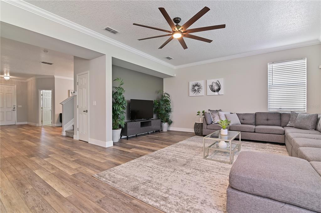 701 Kettering Road Davenport, FL 33897 - Photo 7 of 41 a living room with furniture and a flat screen tv