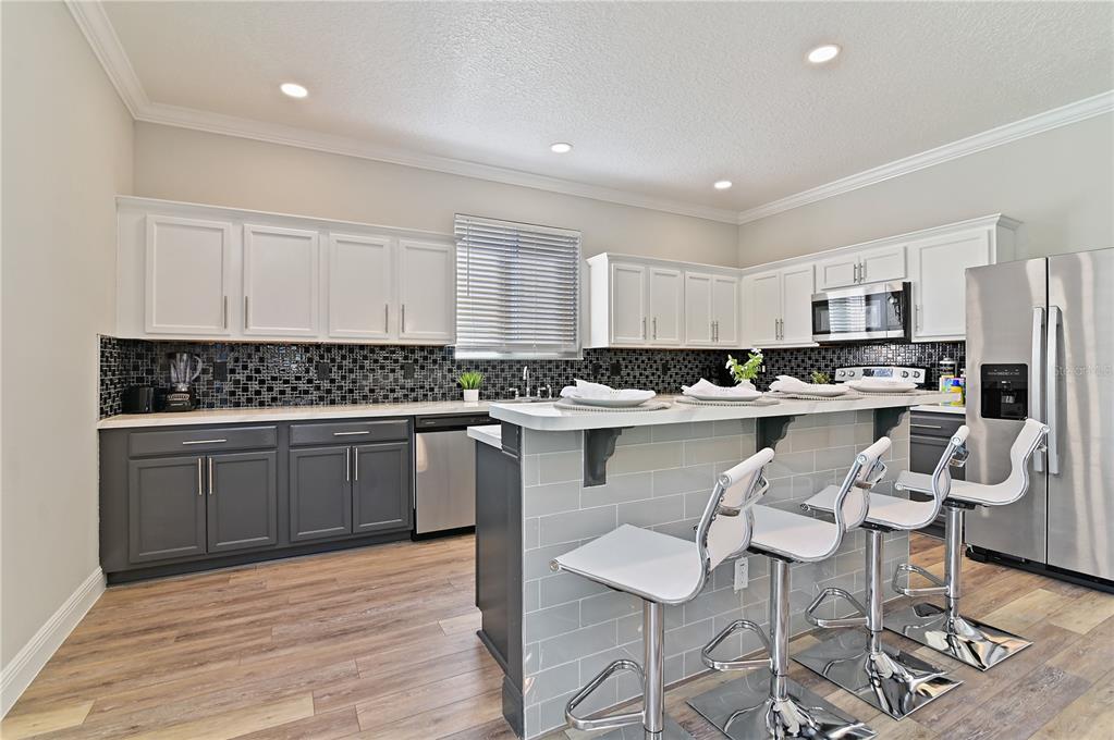 701 Kettering Road Davenport, FL 33897 - Photo 10 of 41 a kitchen with a refrigerator and cabinets