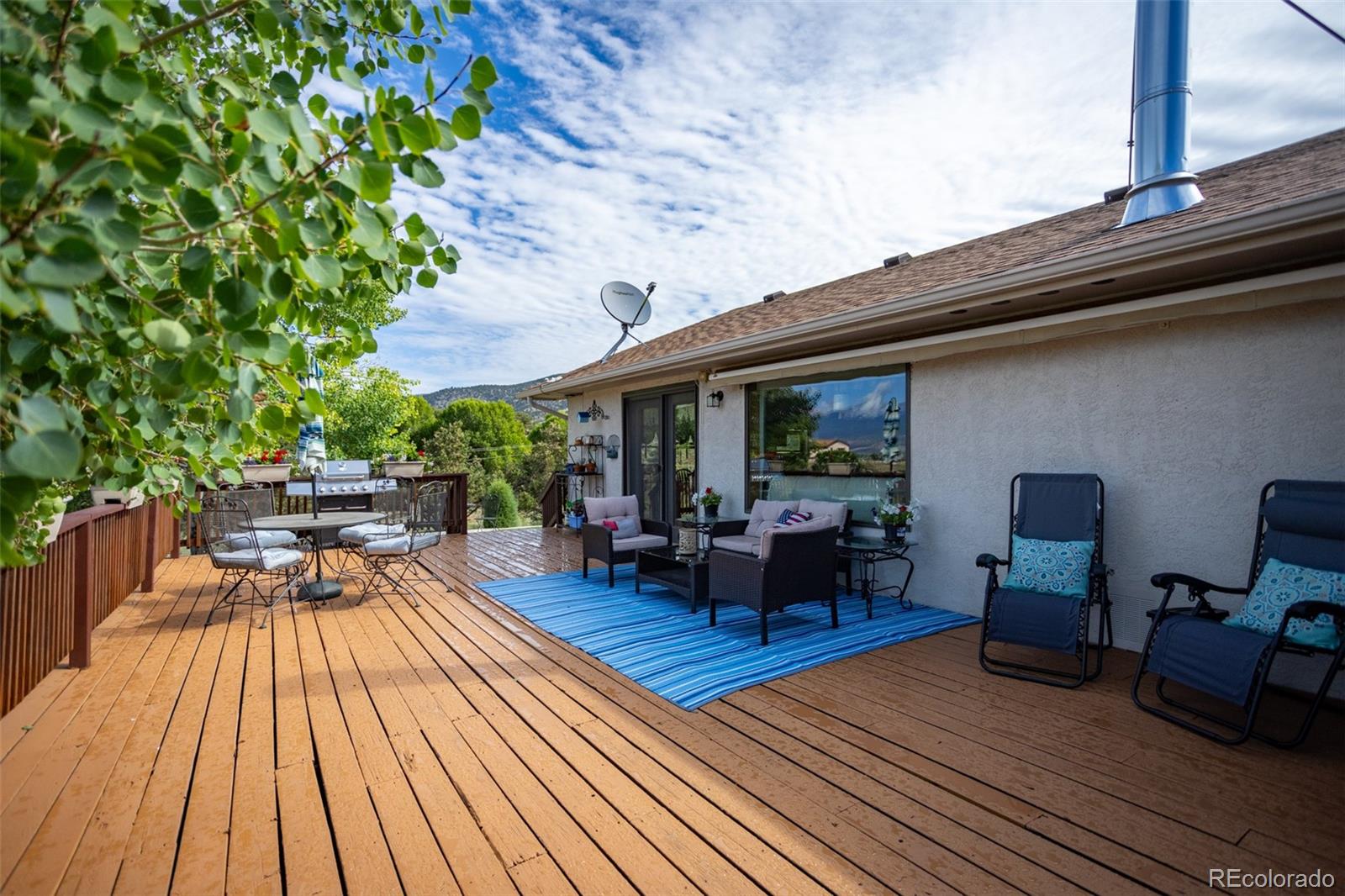 7280 County Road 178 Salida, CO 81201 - Photo 11 of 39 a view of a patio with table and chairs barbeque with wooden floor and plants