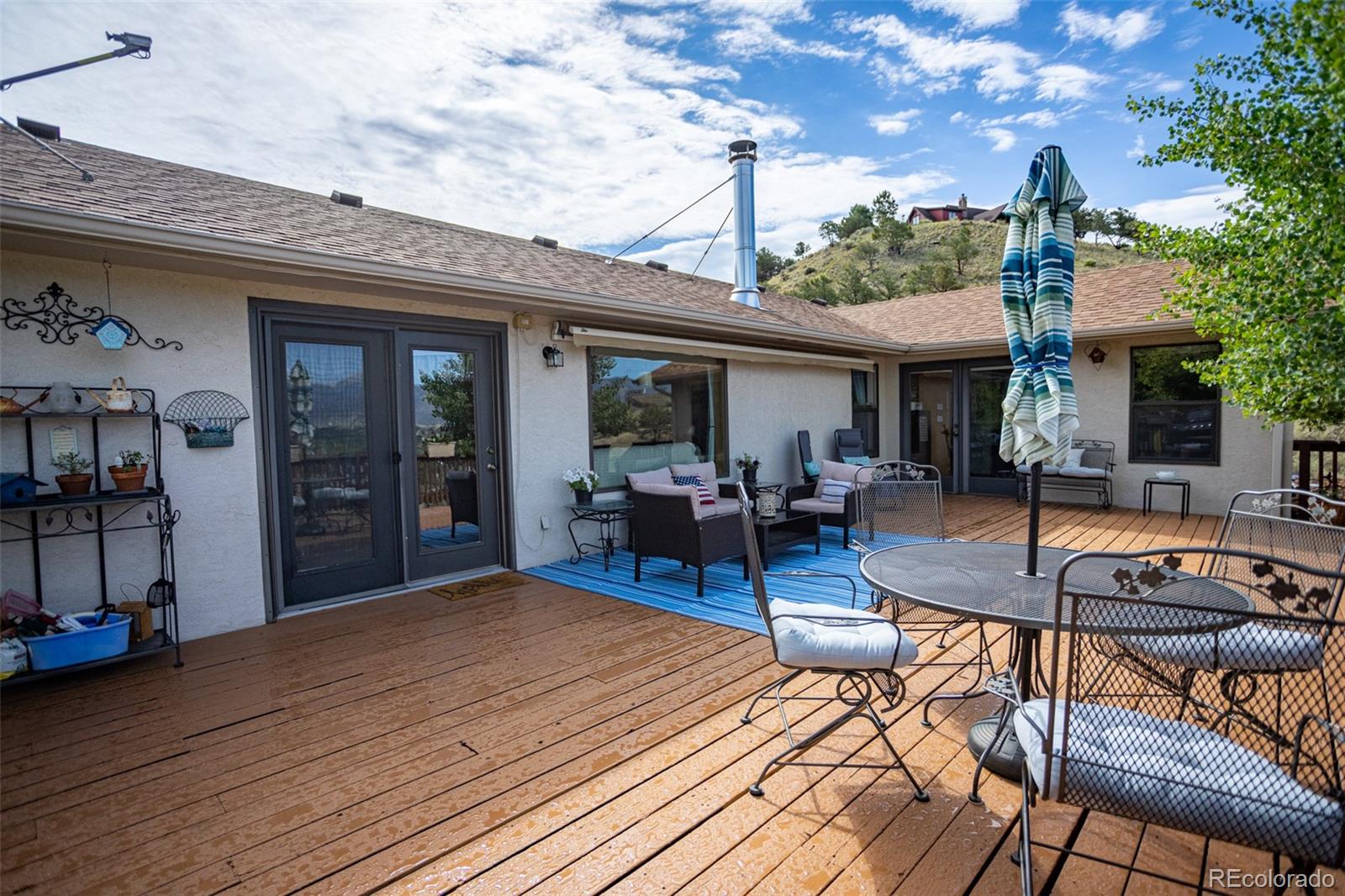 7280 County Road 178 Salida, CO 81201 - Photo 12 of 39 a view of a patio with couches table and chairs with wooden floor and fence
