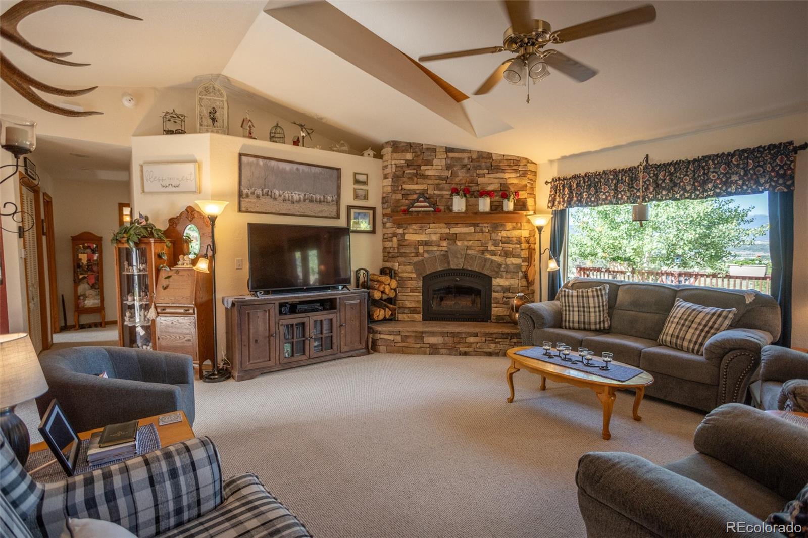 7280 County Road 178 Salida, CO 81201 - Photo 15 of 39 a living room with furniture a flat screen tv and a fireplace
