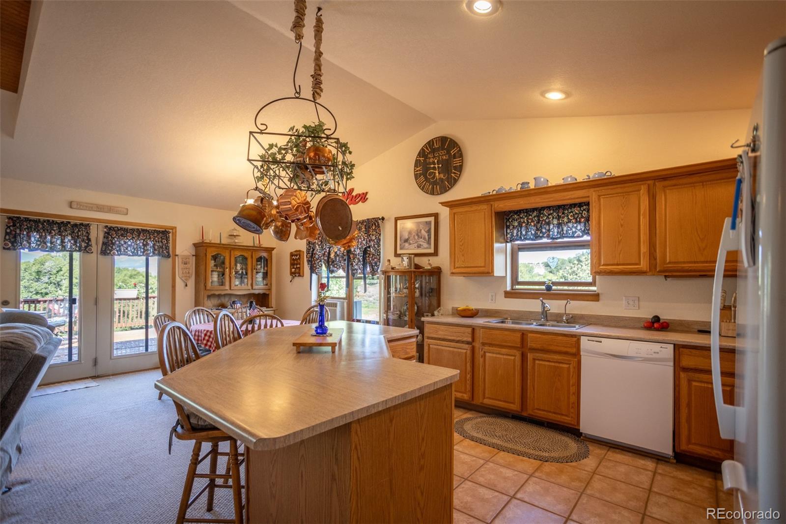 7280 County Road 178 Salida, CO 81201 - Photo 19 of 39 a kitchen with a sink dishwasher a stove and a dining table with wooden floor