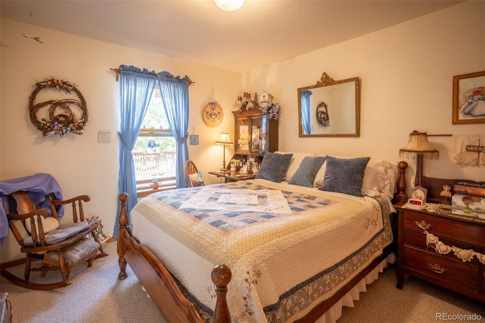 7280 County Road 178 Salida, CO 81201 - Photo 28 of 39 a bedroom with a bed a chair and next to a window