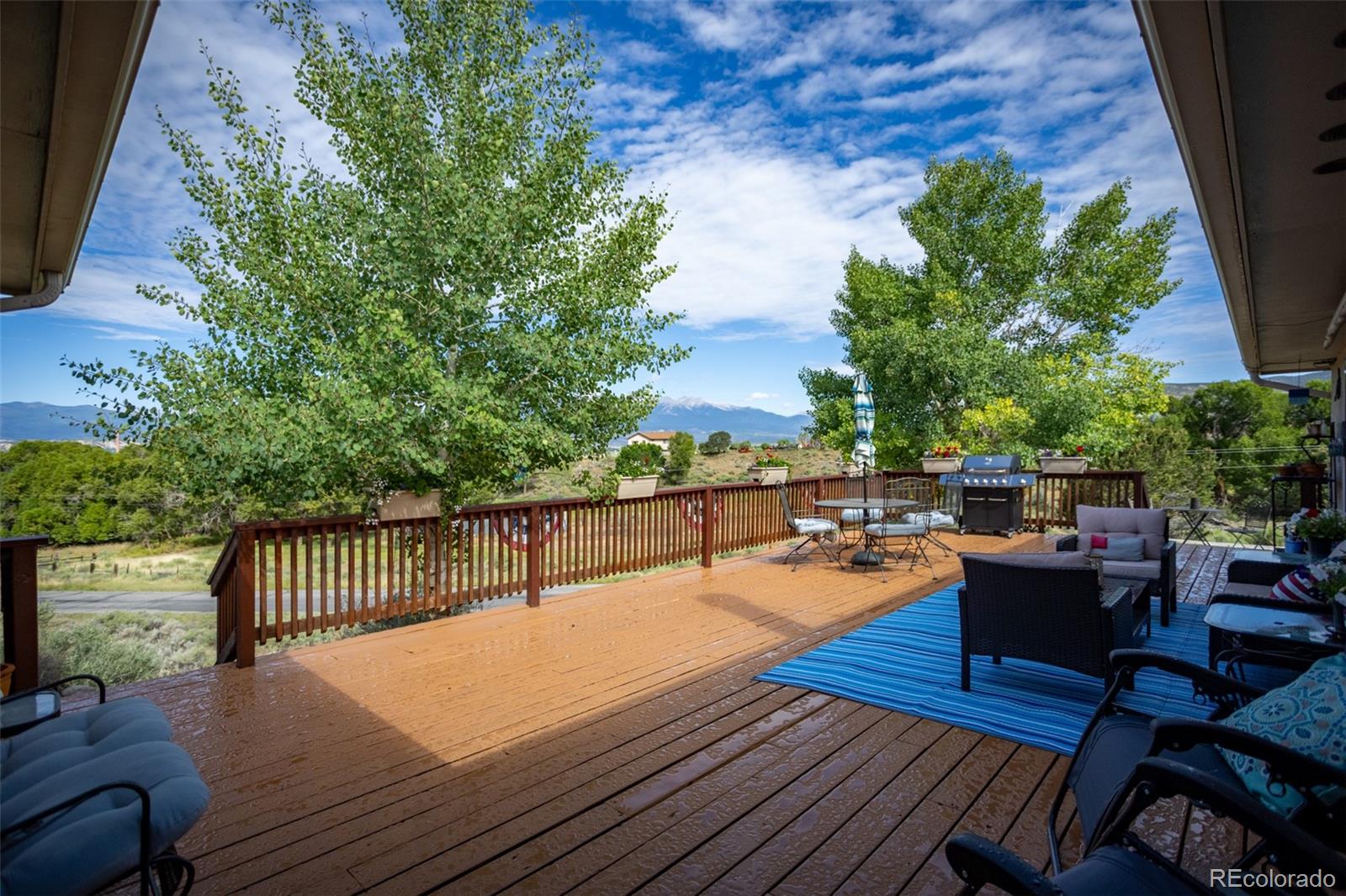 7280 County Road 178 Salida, CO 81201 - Photo 8 of 39 a view of a patio with dining table and chairs with wooden floor