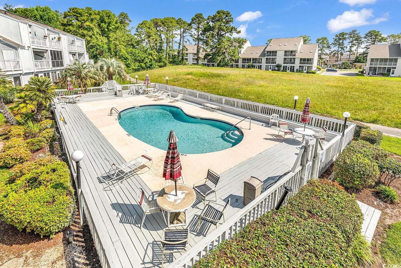 3700 Golf Colony Lane, Unit 25G Little River, SC 29566 - Photo 17 of 18 Community pool with a patio area