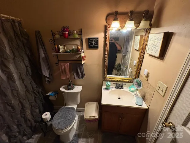 a bathroom with a sink mirror and toilet