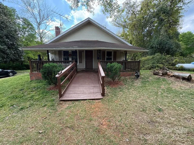 a front view of a house with a yard porch and furniture