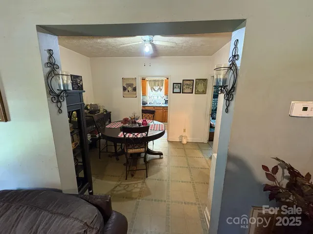 a view of a dining room with furniture and chandelier