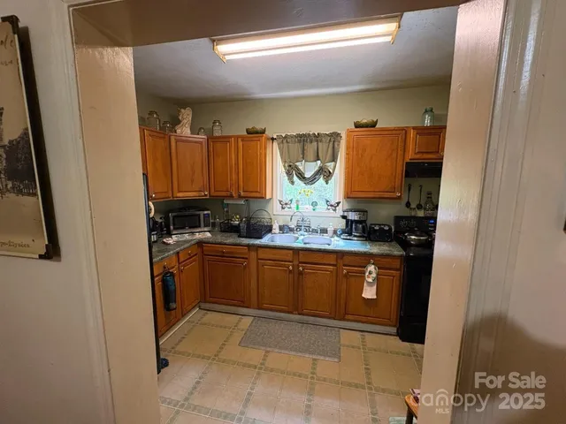 a kitchen with stainless steel appliances granite countertop a sink and cabinets