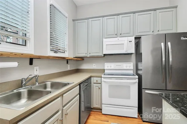 a kitchen with appliances cabinets and a sink