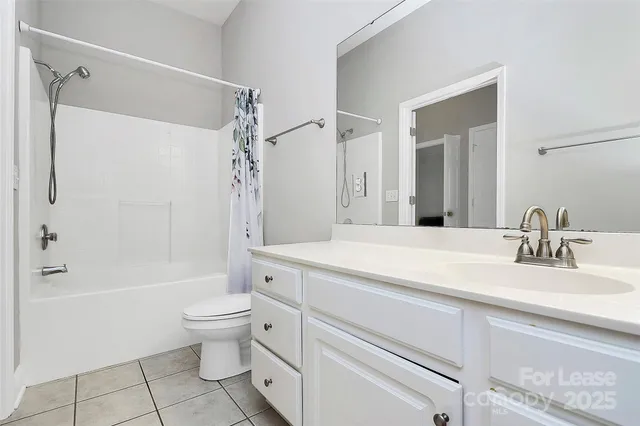 a bathroom with a sink a toilet and a large mirror