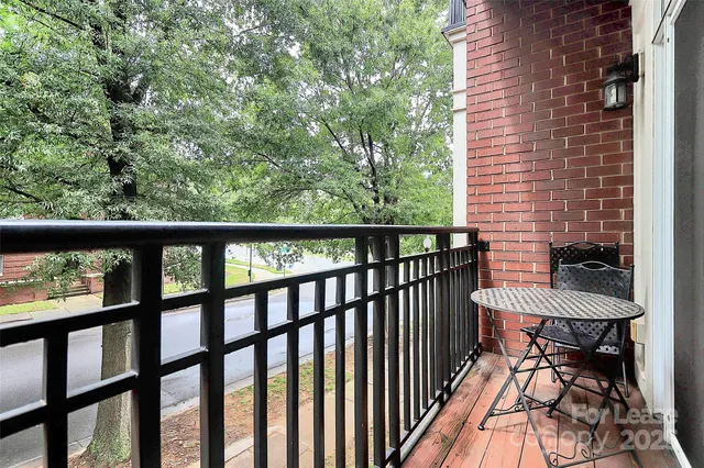 a view of a balcony with furniture and a gate