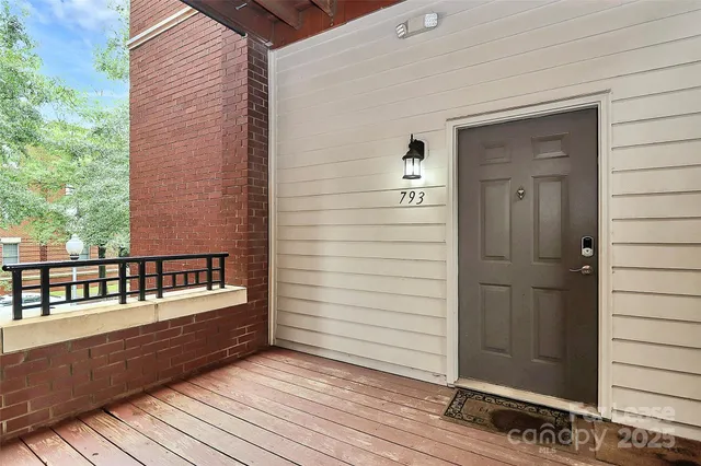 a view of a balcony with two chairs and wooden floor