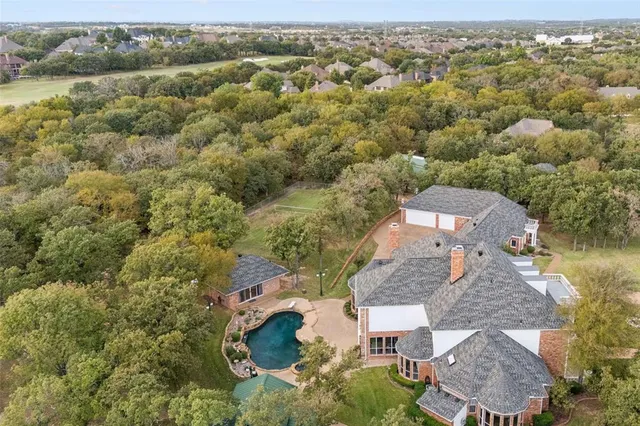 an aerial view of a house with a lake view