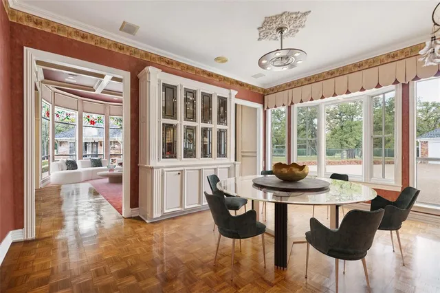 a dining room with furniture and large windows
