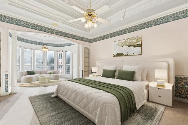 a spacious bedroom with a large bed and a chandelier