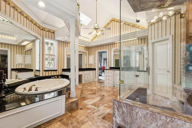 a bathroom with a tub a sink and a mirror