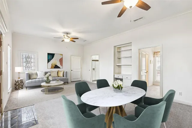a view of a dining room with furniture and a chandelier