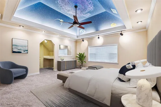 a spacious bedroom with a bed and ceiling fan
