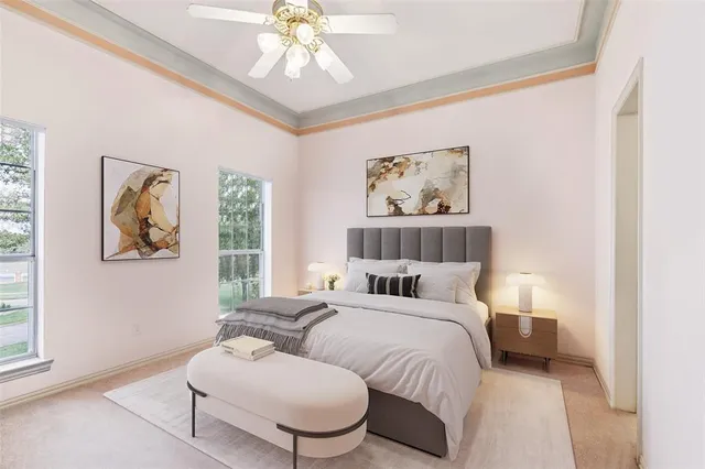 a bedroom with bed and a painting on the wall