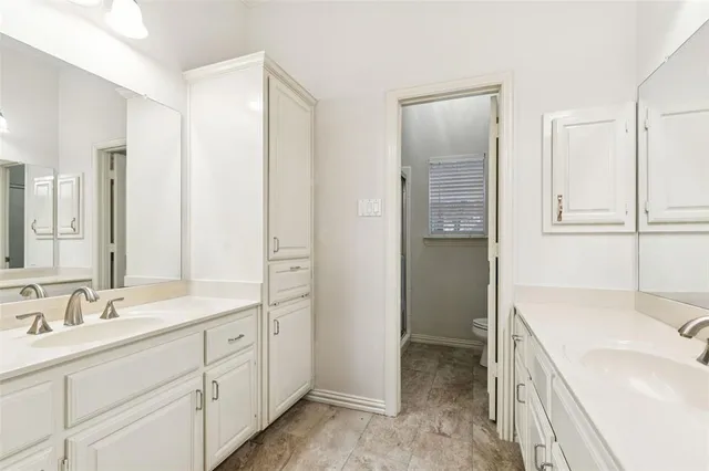 a bathroom with a sink and a mirror with bathtub