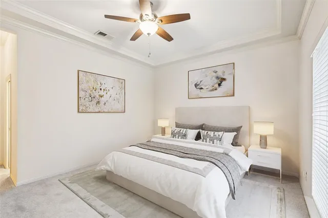 a bedroom with bed and paintings on the wall