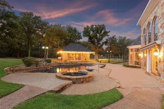 a view of a backyard with sitting area and tree s