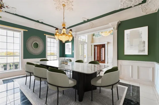 a view of a dining room with furniture and a chandelier
