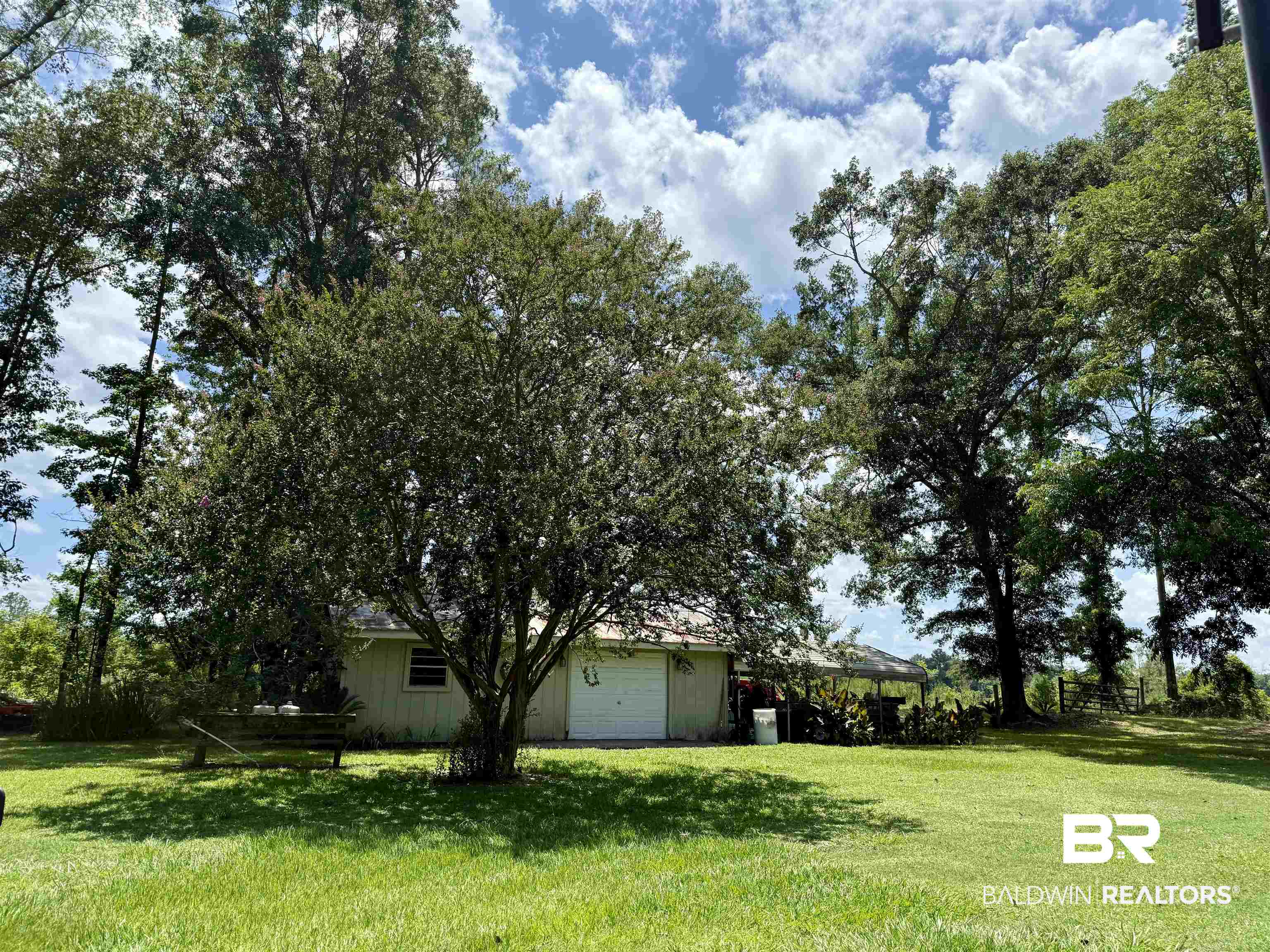 5971 Appleton Road Brewton, AL 36426 - Photo 21 of 23 View of green lawn featuring a garage