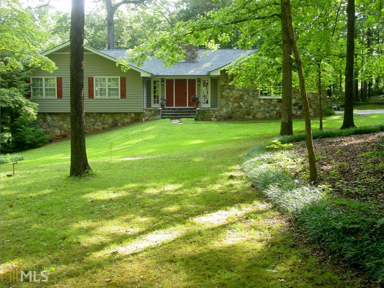 1122 Flat Rock Road Stockbridge, GA 30281 - Photo 1 of 1 a view of house in front of a big yard with large trees