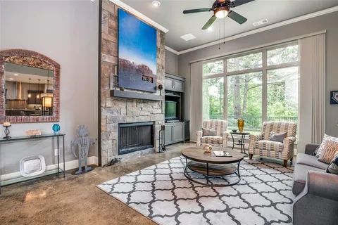 a living room with lots of furniture and a large window