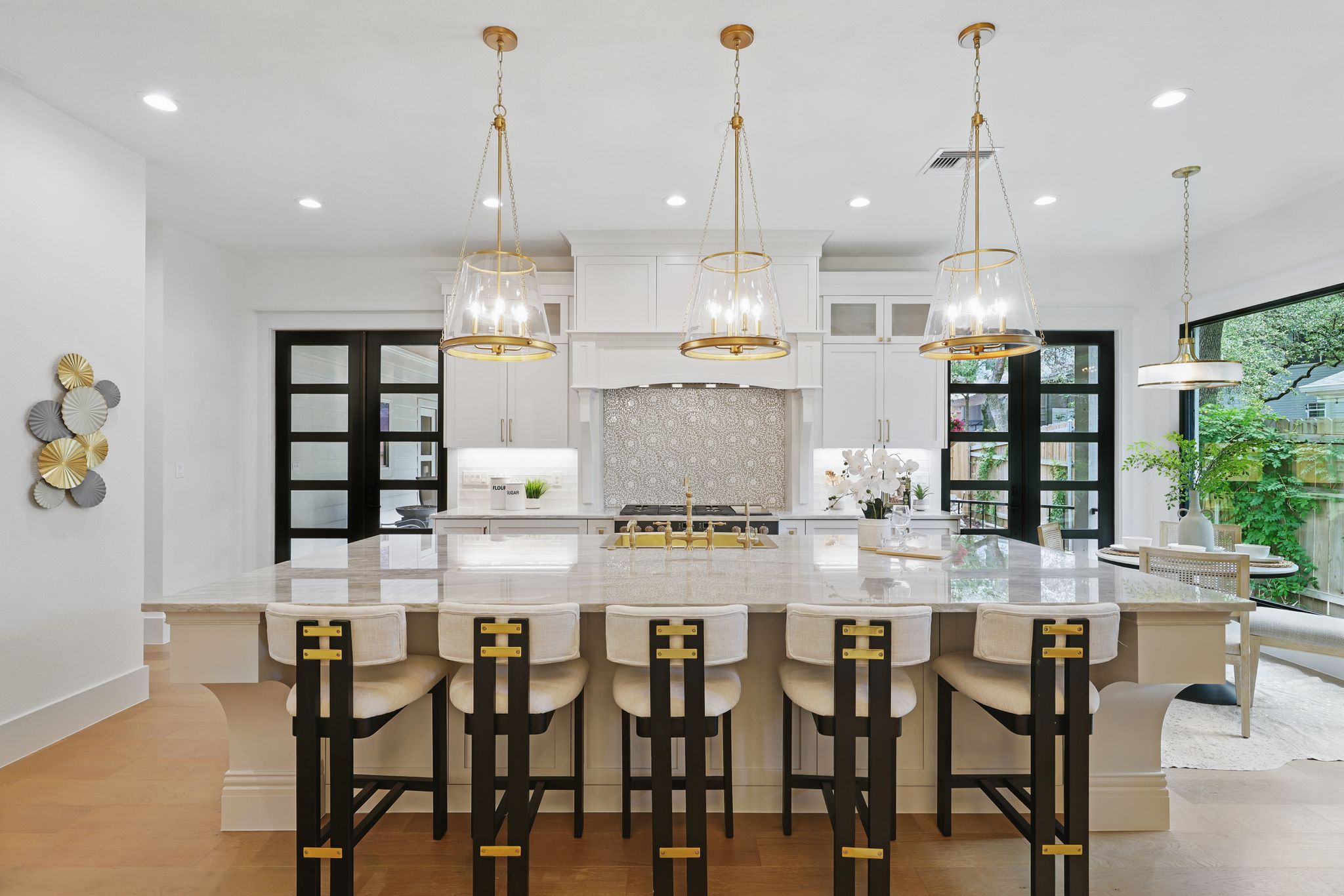 6905 Rudi Cove Austin, TX 78759 - Photo 12 of 36 a kitchen with kitchen island a dining table chairs and white cabinets