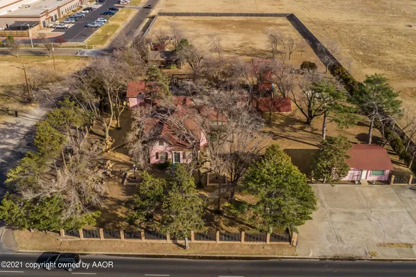 an aerial view of residential houses with outdoor space