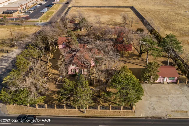 an aerial view of residential houses with outdoor space