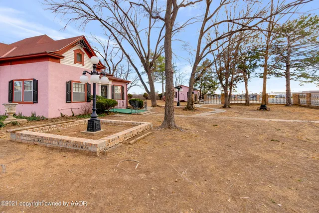 a view of swimming pool with a yard covered in snow
