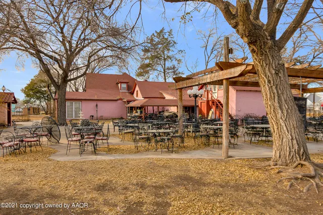 a view of a dining room with furniture and a chandelier