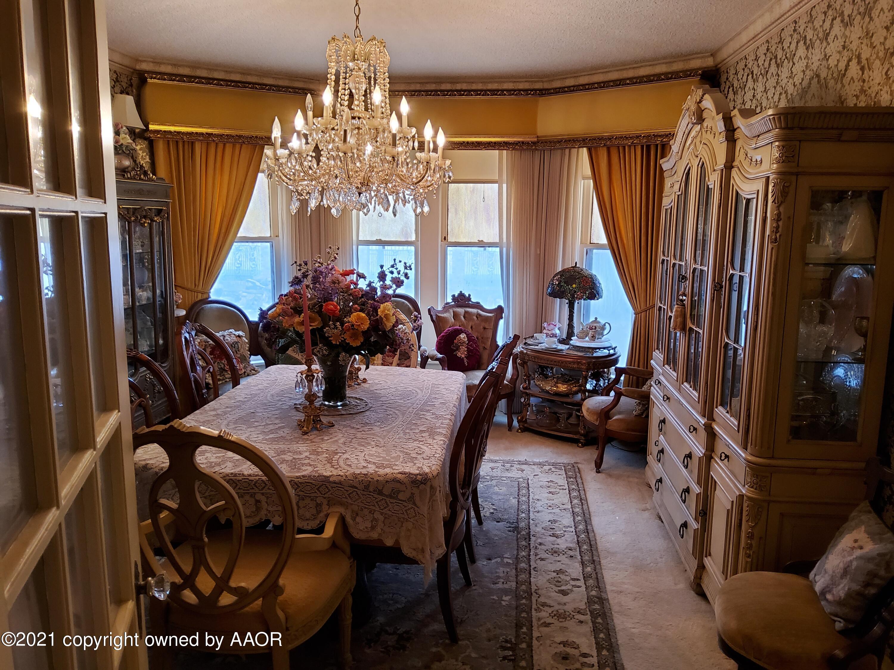 2501 South Grand Street Amarillo, TX 79103 - Photo 36 of 80 a view of a dining room with furniture and a chandelier