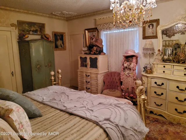 a bedroom with a bed and a mirror