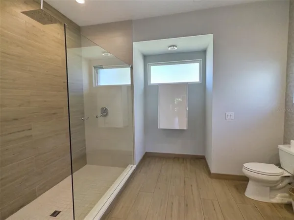 a bathroom with a toilet and a shower