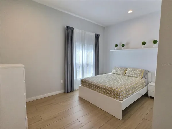 a bedroom with a bed and window