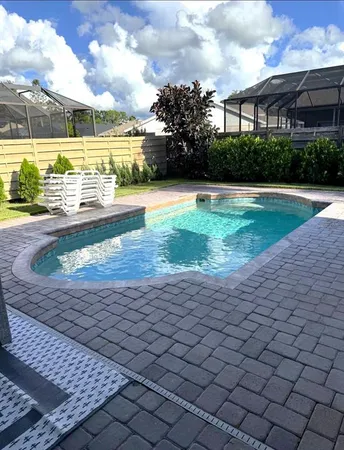 a view of a swimming pool and a yard