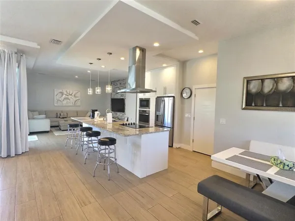 a living room with furniture and kitchen view